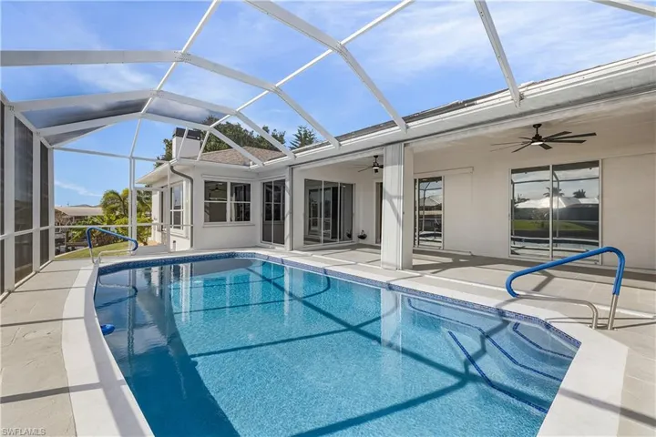 Swimming pool featuring a lanai and screened enclosure