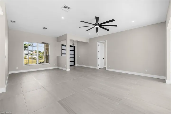 Living room with a ceiling fan and recessed lighting