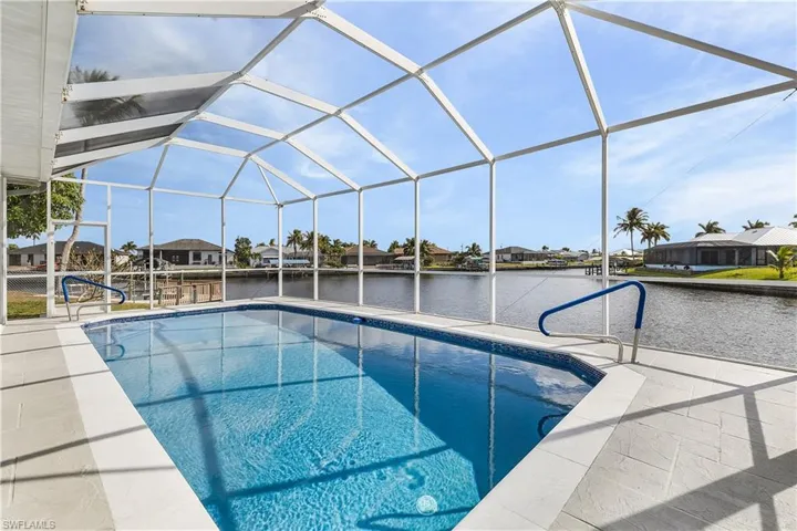 Outdoor pool featuring a water view, a lanai, and a screened enclsoure