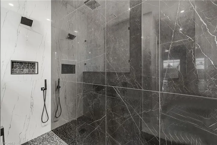 Primary bathroom featuring a marble finish shower