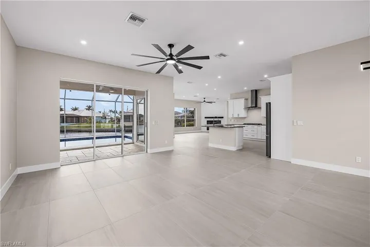 Living room featuring recessed lighting, ceiling fan, and a view of the lanai and pool
