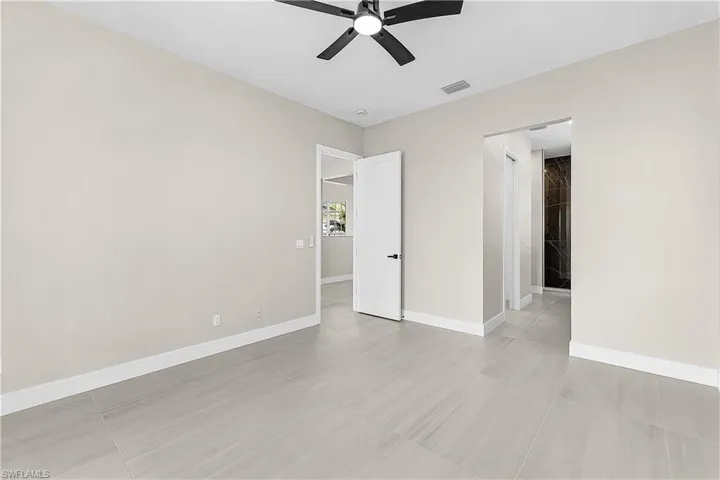 Primary bedroom with a ceiling fan