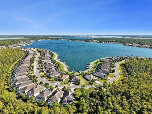 Aerial perspective of a waterfront residential enclave featuring a large lake.