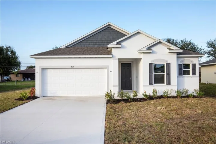 Ranch-style home featuring roof with shingles, stucco siding, and driveway