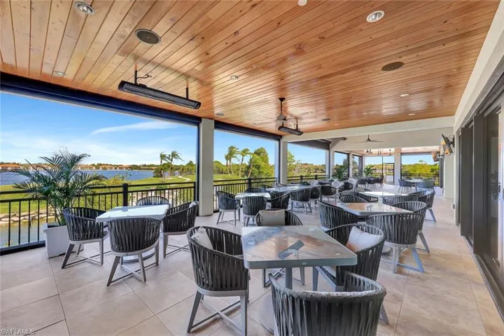View of patio featuring outdoor dining space, a ceiling fan, and a water view