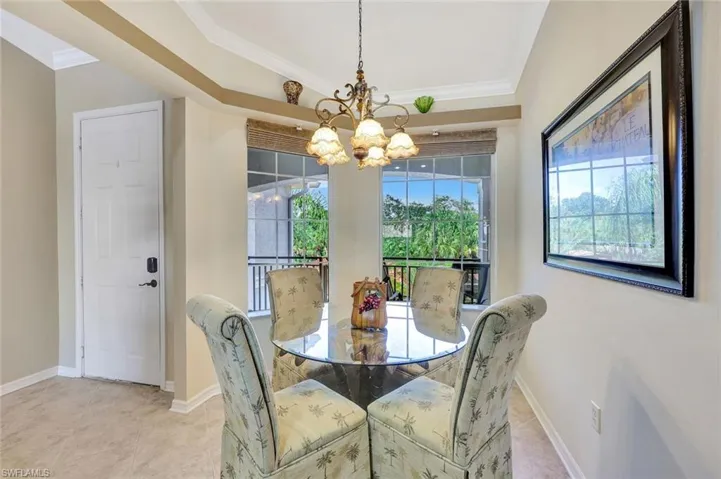 Dining area featuring crown molding, a chandelier, and tile patterned floors