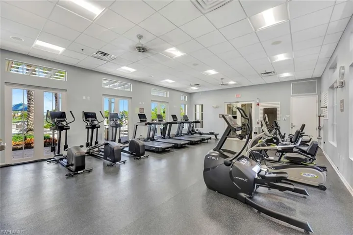 Workout area with a paneled ceiling and ceiling fan