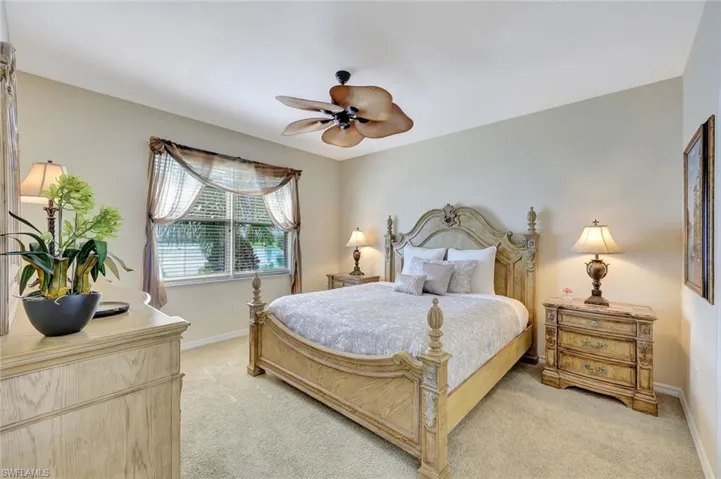 Bedroom featuring light colored carpet and ceiling fan