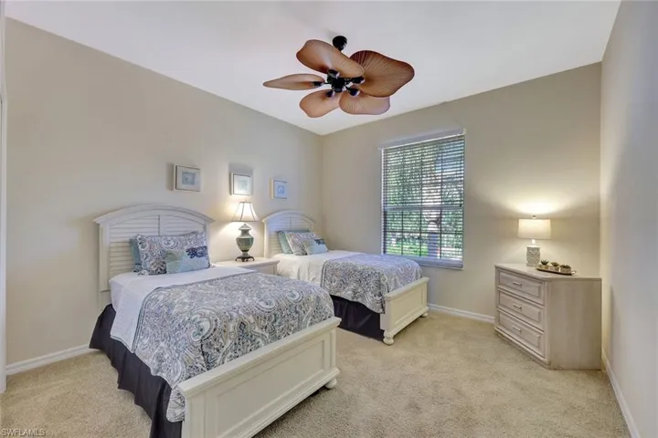 Bedroom featuring light carpet and ceiling fan