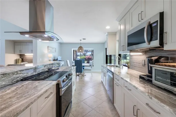 Glass Tile Back Splash, Upper Level Exotic Granite, New SS Appliances, SS Sink w/Large Pass Thru Window