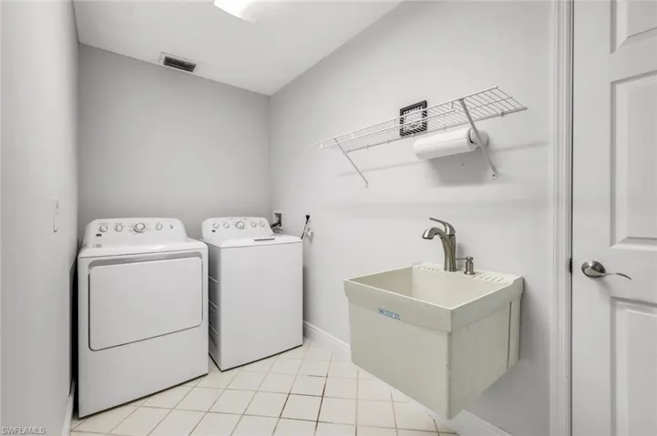 Separate Laundry Room between Garage and Living Area- Front Load Washer & Dryer Coming! Utility Sink, Closet Not Shown- Tile Flooring