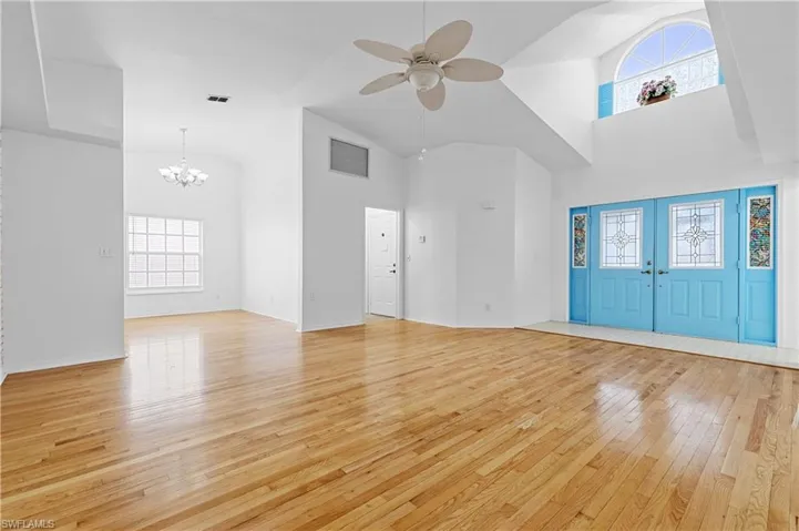Looking from front great/family room at entry double doors.  Door to garage off to left by the laundry room.