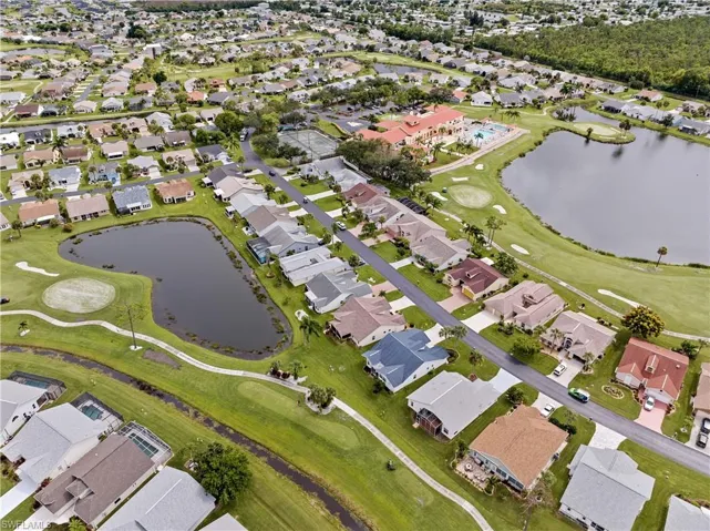 Home (blue roof) showing back pond and golf course view.  Note the red roof of the clubhouse - a short distance away.