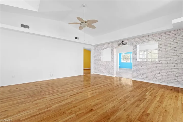 Looking from front of home towards second family room area and entry into primary bedroom.