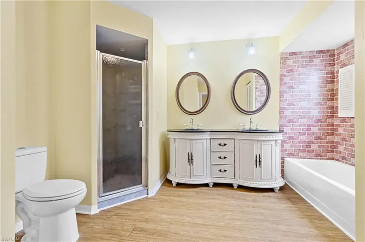 Dual sinks, tub and linen closet.