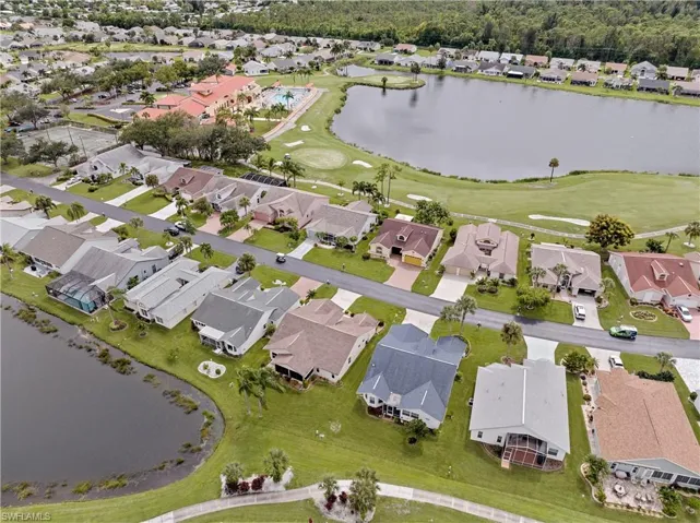 Home (blue roof) showing back pond and golf course view.  Note the red roof of the clubhouse - a short distance away.
