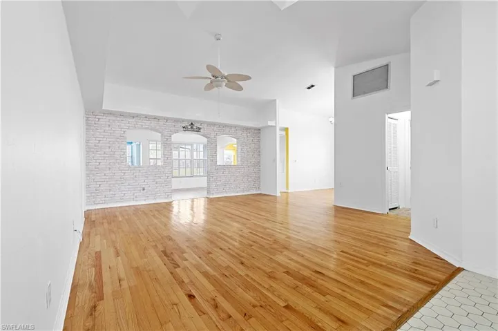 Looking in from front entrance into high ceiling great/family room into second family room.