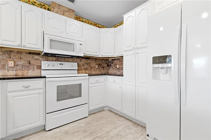 Granite Counters and beautiful white wood cabinates.