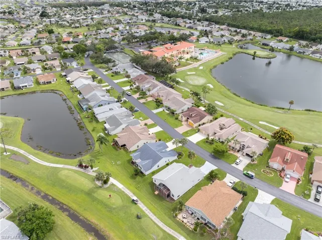 Another look at home,  (blue roof) showing back pond and golf course view.  Note the red roof of the clubhouse - a short distance away.
