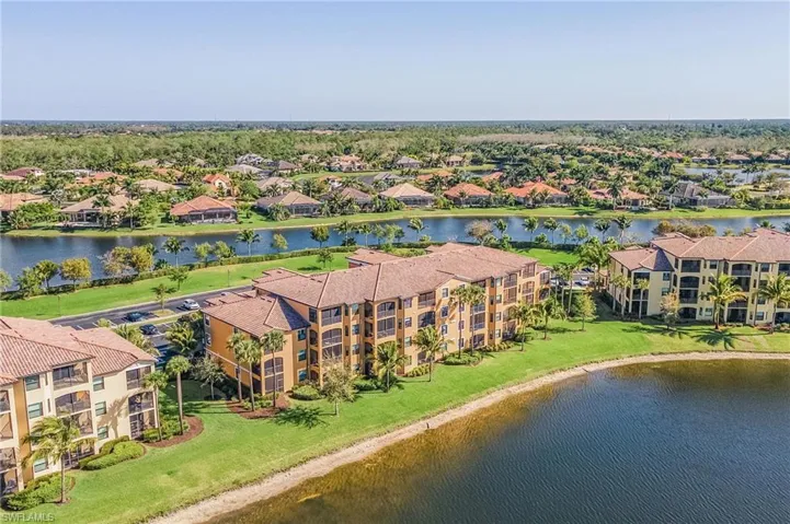 Drone / aerial view of a large body of water and apartment complex