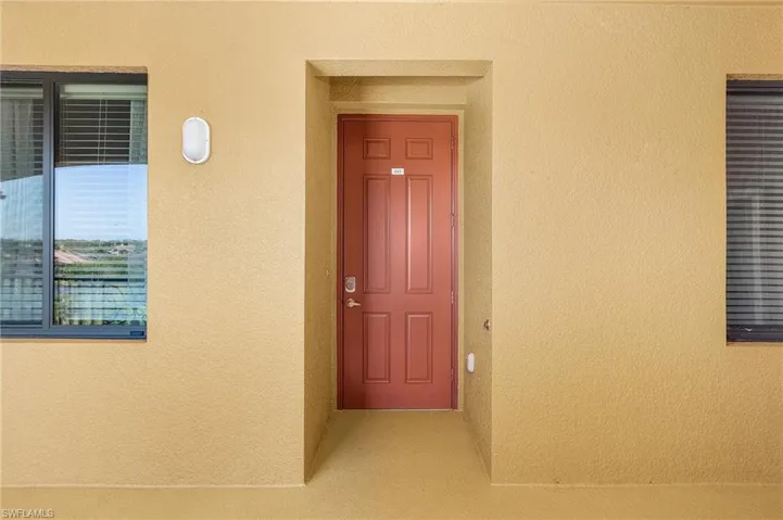 Property entrance featuring stucco siding