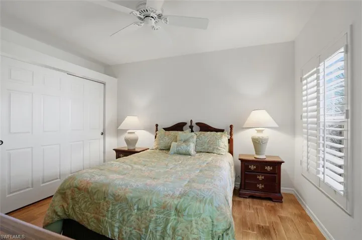 Bedroom with a ceiling fan, a closet, and light wood-type flooring