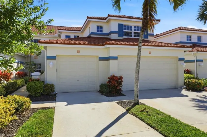 Mediterranean / spanish house featuring driveway, stucco siding, and a tile roof