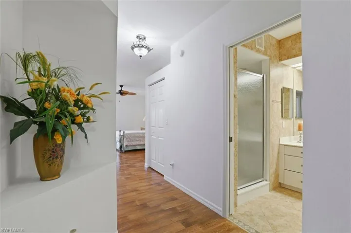 Corridor featuring wood finished floors and baseboards