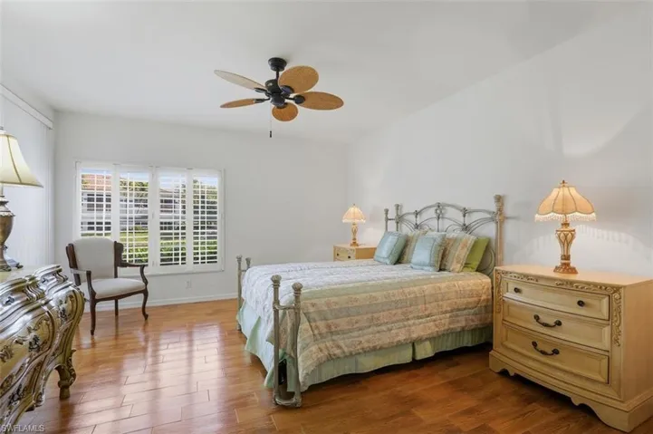 Bedroom featuring wood finished floors and a ceiling fan