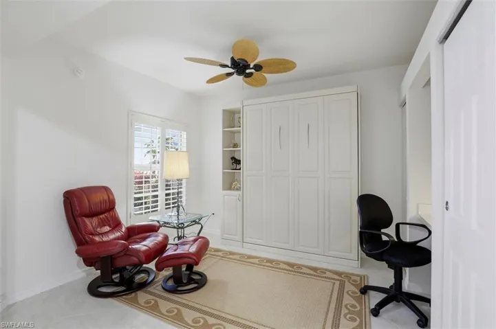 Home office with ceiling fan and light tile patterned floors