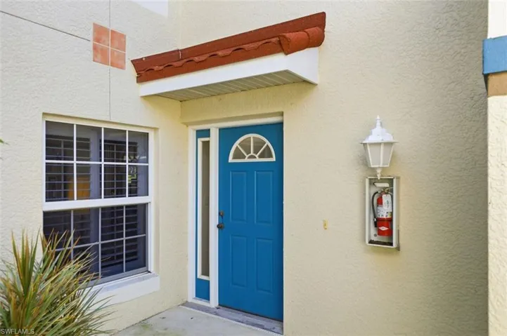 Doorway to property featuring stucco siding