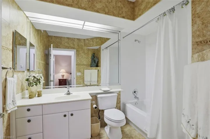 Bathroom with shower / bath combo and vanity