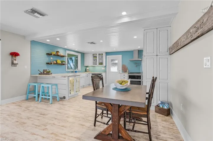 Dining space featuring sink and light wood-type flooring