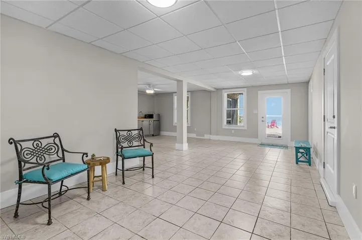 Sitting room featuring a drop ceiling and light tile patterned flooring