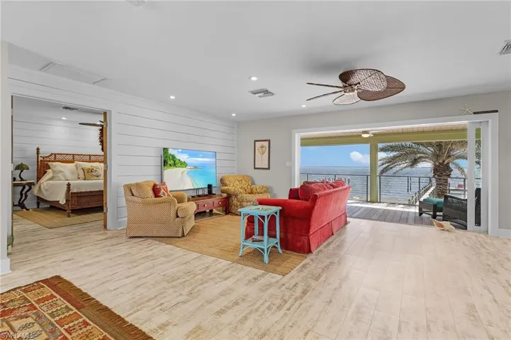 Living room featuring hardwood / wood-style flooring and ceiling fan