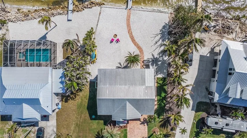 Birds eye view of property with a water view