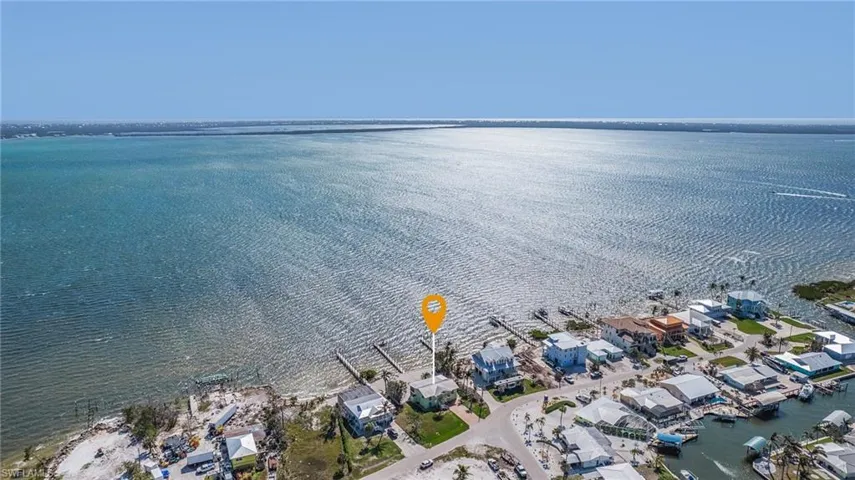 Birds eye view of property with a water view
