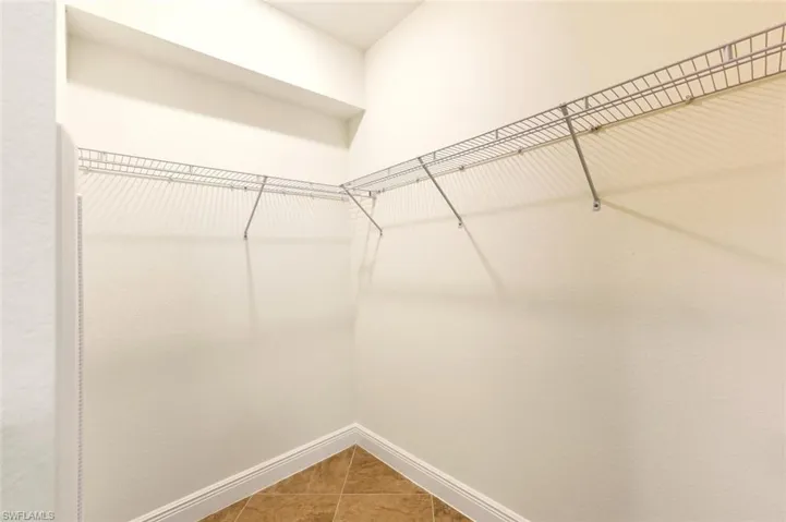 Walk in closet featuring light tile patterned floors