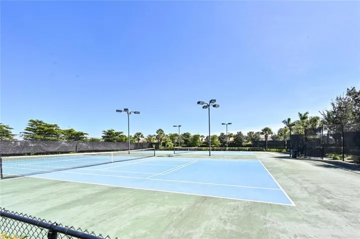 View of tennis court with community basketball court