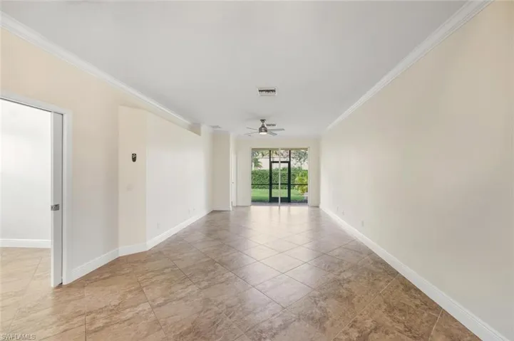 Empty room featuring crown molding and ceiling fan