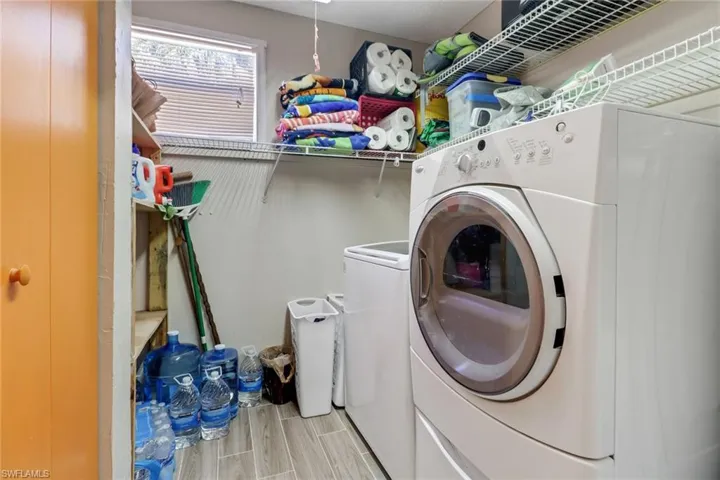 Clothes washing area with laundry area and wood tiled floor
