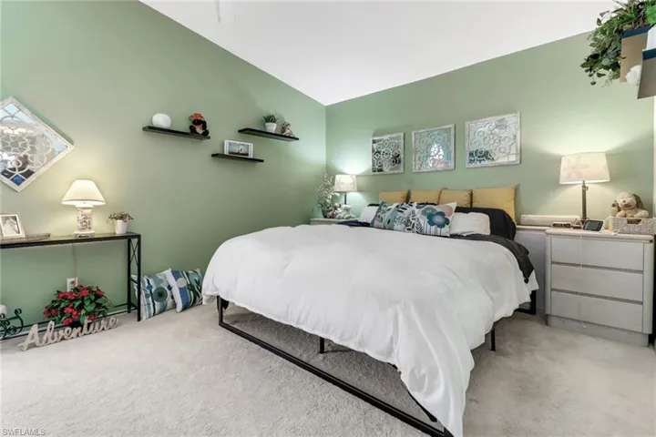 Bedroom with carpet and vaulted ceiling