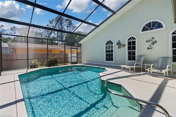 View of pool featuring a lanai, fence, a fenced in pool, and a patio