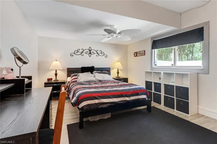 Bedroom featuring wood tiled floor and a ceiling fan