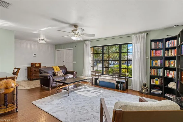 Living room with wood-type flooring and ceiling fan