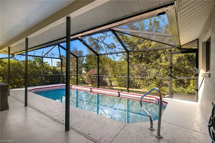 View of swimming pool featuring a lanai and a patio