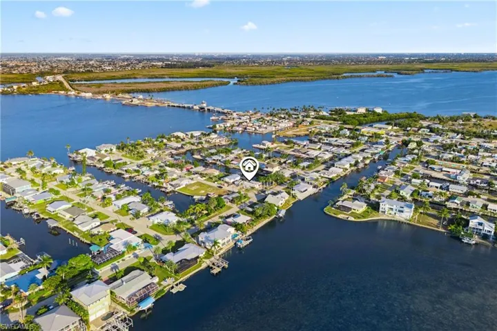 Expansive aerial shot capturing the home’s proximity to water, boating routes, and local amenities.