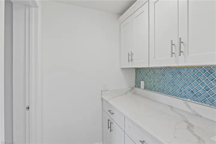 Convenient laundry space with room for washer, dryer, and additional storage.