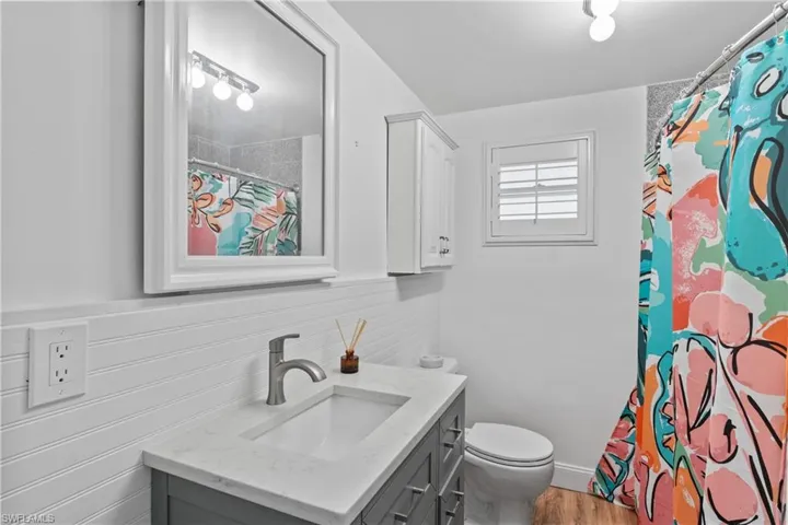 Clean, well-maintained bathroom with functional layout and coastal touches.
