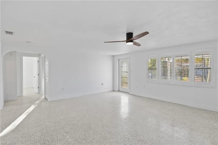 Bright and inviting living area filled with natural light and classic Florida charm.